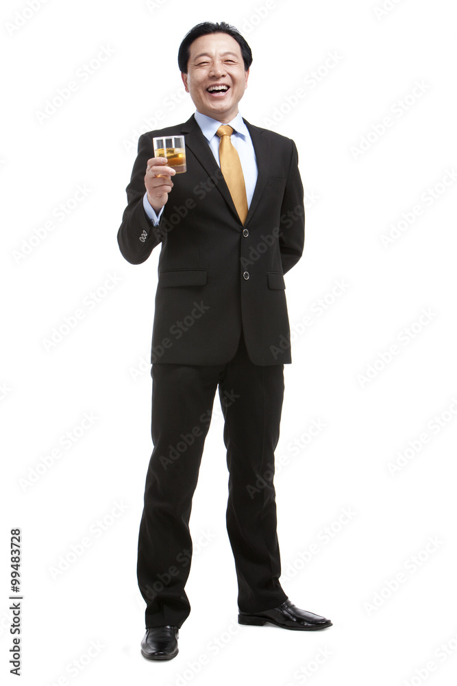 Senior businessman holding a glass of whiskey Senior businessman holding a glass of whiskey