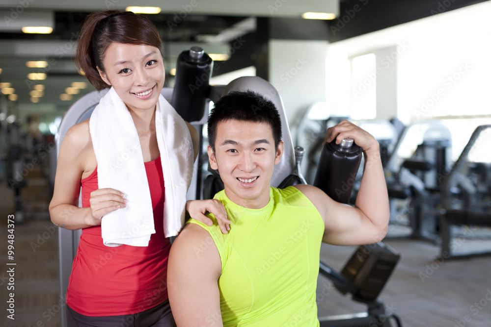 Young Man and Woman Together At Gym Young Man and Woman Together At Gym
