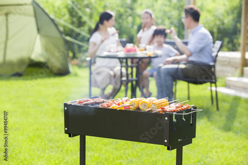 Young family barbecuing outdoors