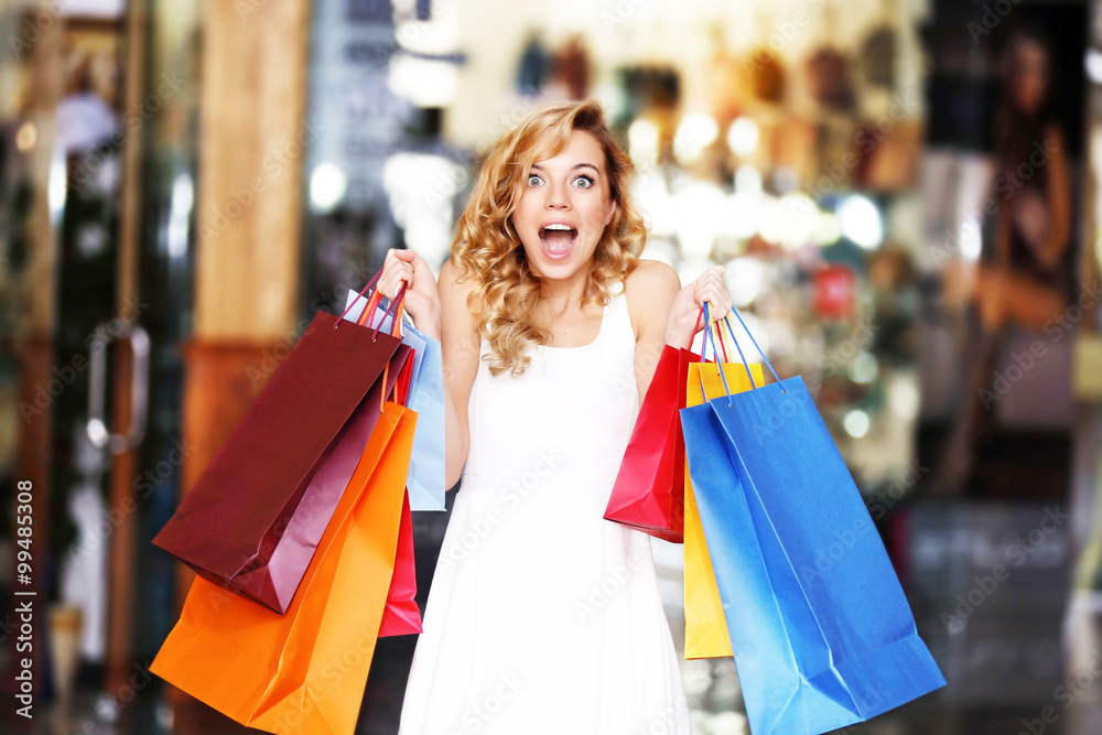 Beautiful young women with bags in shopping center Beautiful young women with bags in shopping center