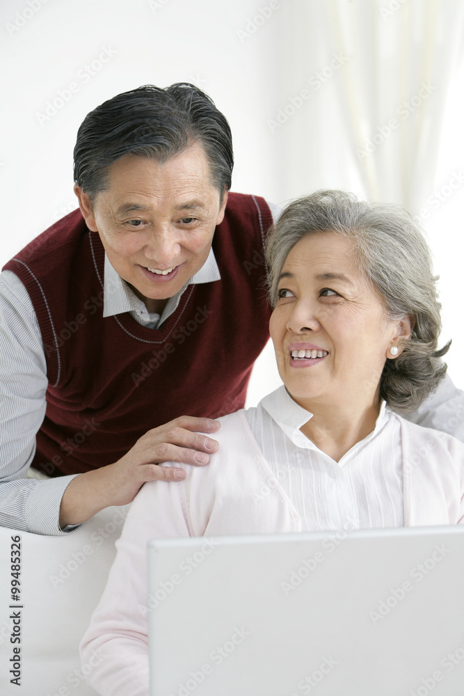 Senior Chinese couple using a laptop Senior Chinese couple using a laptop