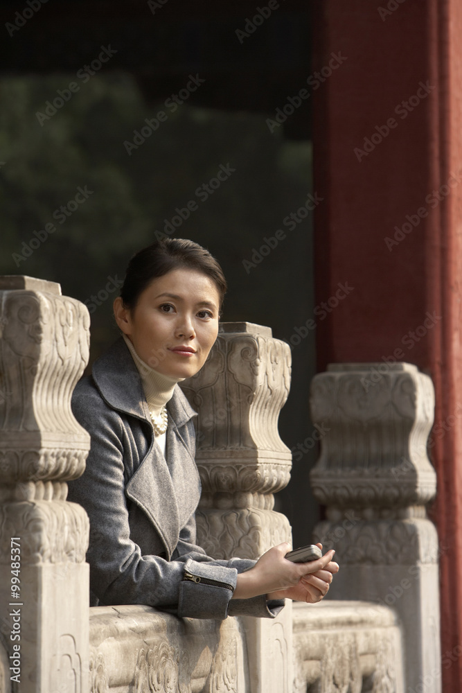 Businesswoman Leaning On A Rail In The Forbidden City In Beijing Businesswoman Leaning On A Rail In The Forbidden City In Beijing
