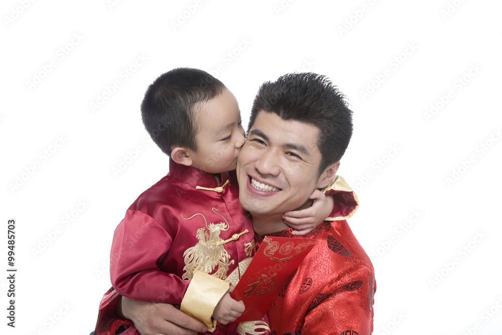 Father and son in Chinese traditional clothes holding red envelope Father and son in Chinese traditional clothes holding red envelope