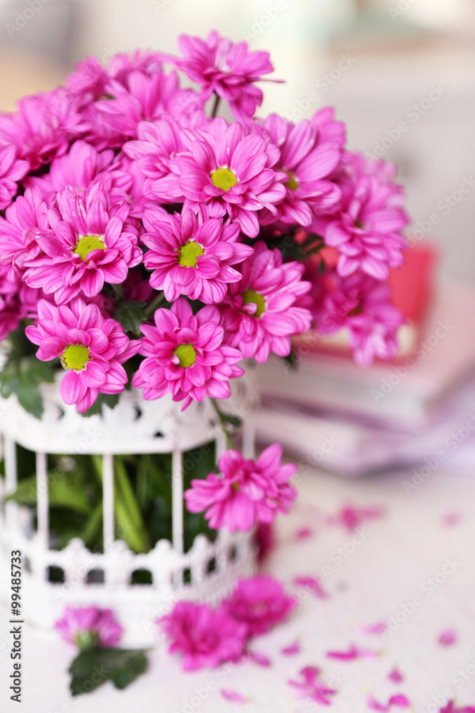 Beautiful flowers in vase on table in room Beautiful flowers in vase on table in room