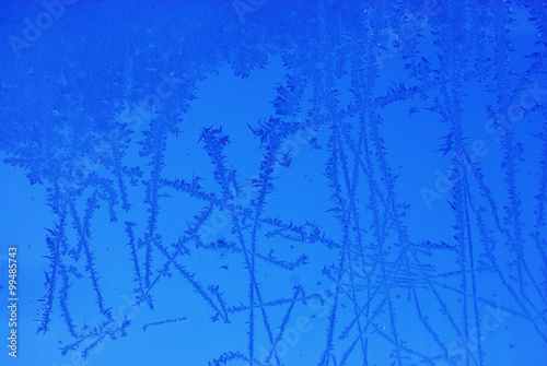 blue ice flower on window in winter