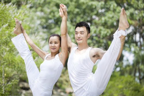 Young couple practicing yoga