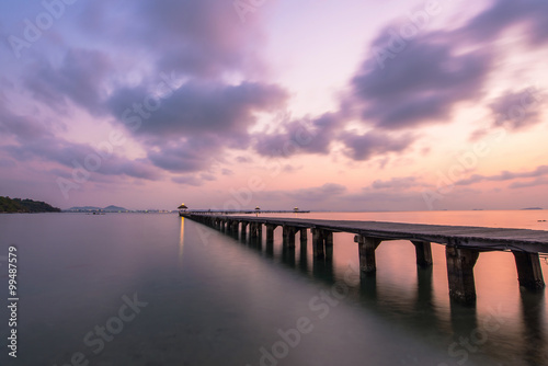 Wooded bridge in the port between sunrise © Suttisak