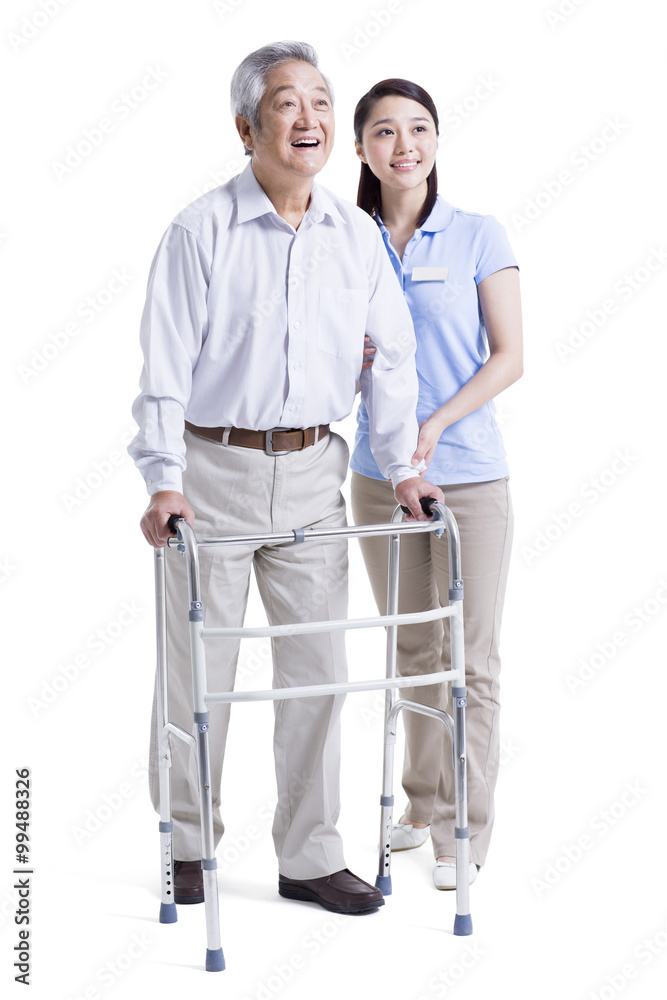 Female nursing assistant helping senior man with walking frame Female nursing assistant helping senior man with walking frame