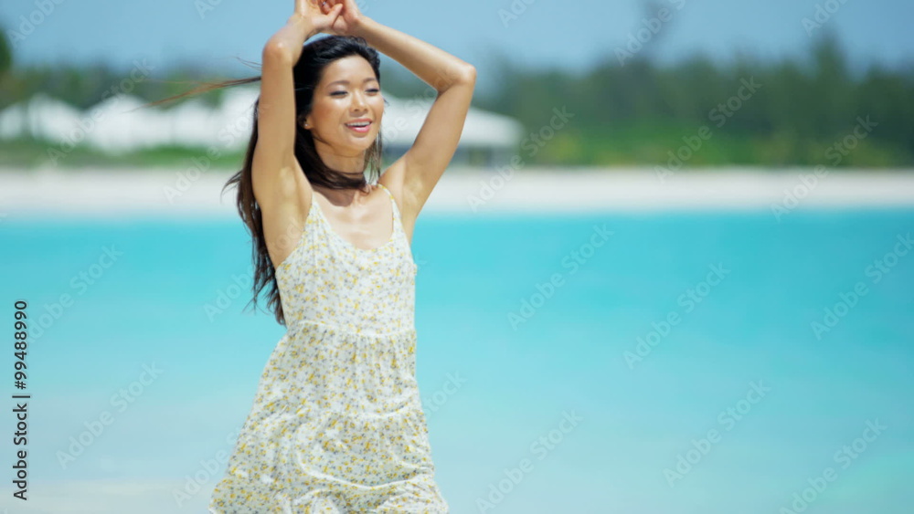 Laughing Asian Chinese girl enjoying tropical island beach Laughing Asian Chinese girl enjoying tropical island beach