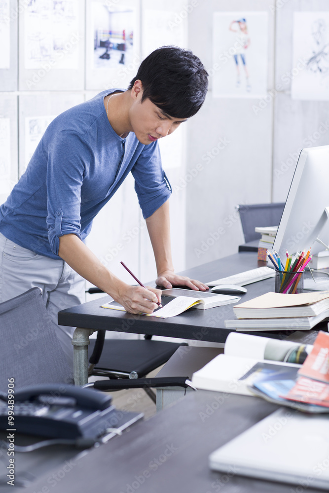 Young man working in the office Young man working in the office