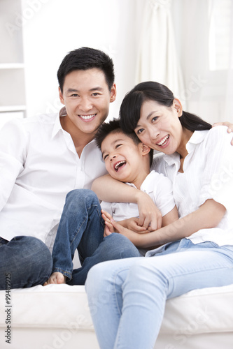 Happy family sitting in sofa