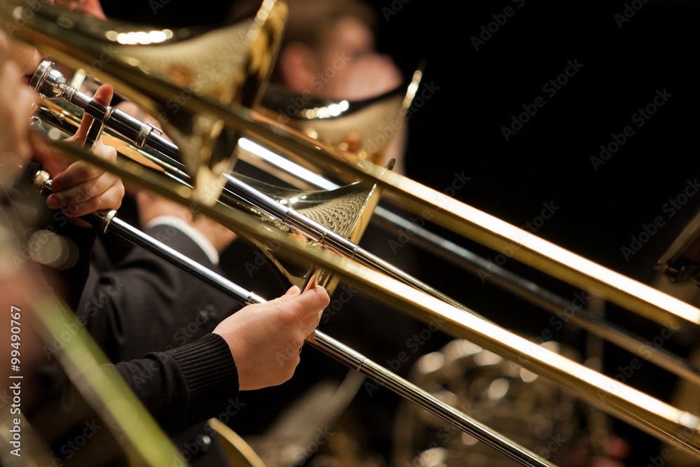 Obraz premium Hands of man playing the trombone in the orchestra