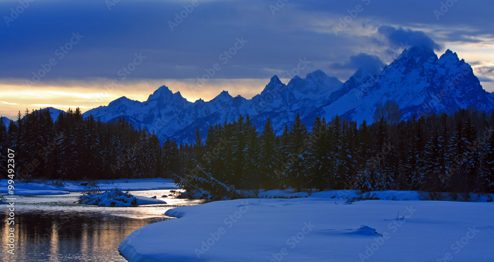 Snake River at twilight below the Grand Teton mountain range peaks in the Central Rocky mountains in Grand Tetons National Park in Wyoming USA near the town of Jackson during the winter