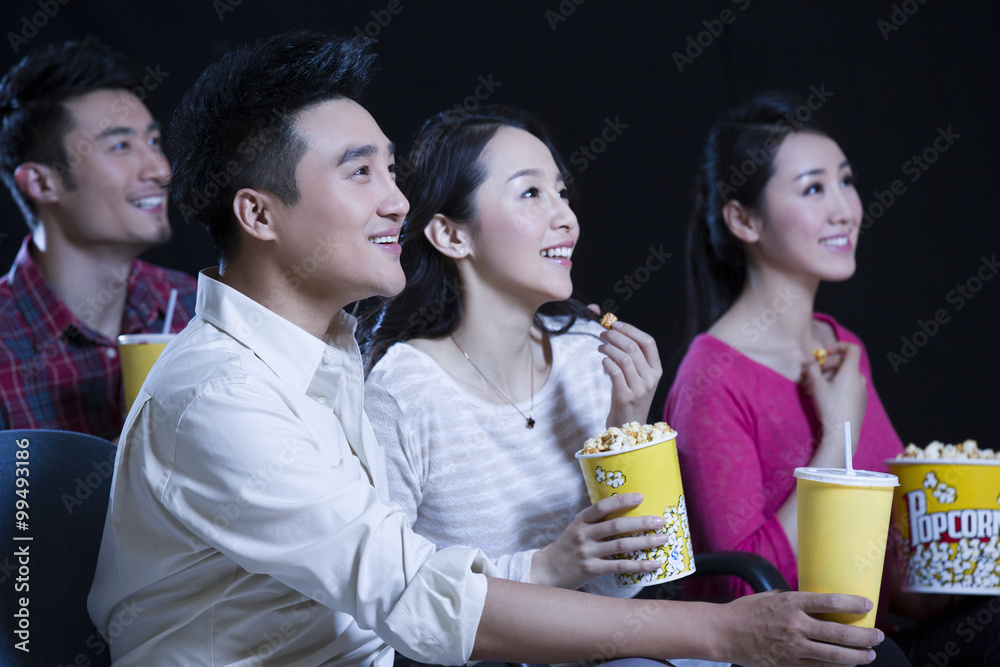 Young couple watching movie in cinema Young couple watching movie in cinema