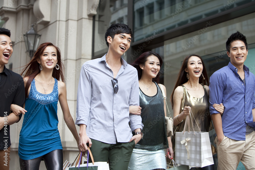 Fototapeta premium Excited young people go shopping on the street of Hong Kong