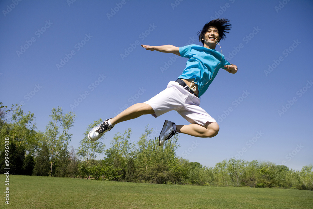 Young man jumping in air at park Young man jumping in air at park