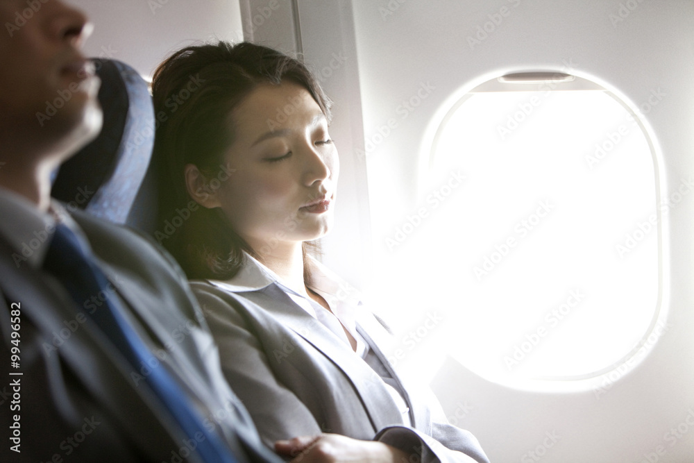 Businesspeople resting on the flight Businesspeople resting on the flight
