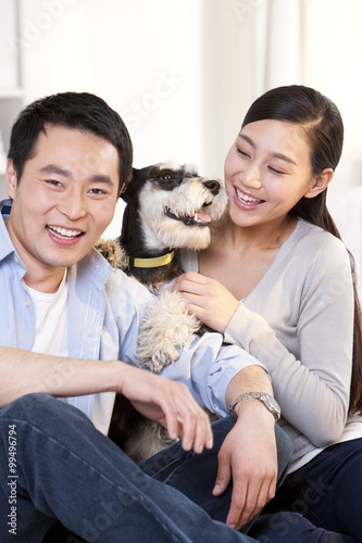 Young couple with pet schnauzer