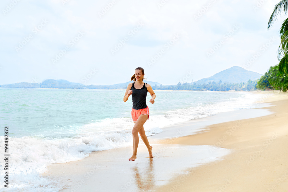 Fitness. Sporty Young Female Runner Running On Beach. Athletic Fit Woman Jogging During Workout Outside. Sports, Exercising, Healthy Lifestyle. Health Concept Fitness. Sporty Young Female Runner Running On Beach. Athletic Fit Woman Jogging During Workout Outside. Sports, Exercising, Healthy Lifestyle. Health Concept