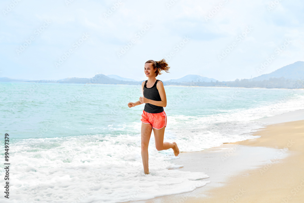 Fitness. Sporty Young Female Runner Running On Beach. Athletic Fit Woman Jogging During Workout Outside. Sports, Exercising, Healthy Lifestyle. Health Concept Fitness. Sporty Young Female Runner Running On Beach. Athletic Fit Woman Jogging During Workout Outside. Sports, Exercising, Healthy Lifestyle. Health Concept