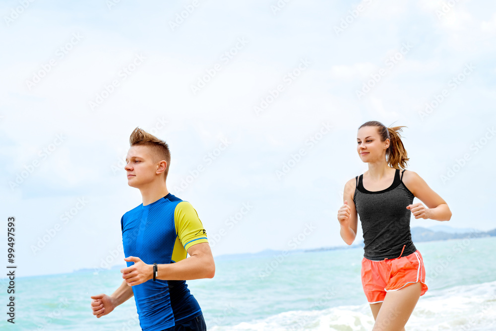 Healthy Lifestyle. Athletic Runner Couple Running On Beach, Training For Marathon. Sporty Fit People Jogging Near Sea ( Ocean ) During Outdoor Workout. Sports And Fitness. Exercising. Health Concept Healthy Lifestyle. Athletic Runner Couple Running On Beach, Training For Marathon. Sporty Fit People Jogging Near Sea ( Ocean ) During Outdoor Workout. Sports And Fitness. Exercising. Health Concept