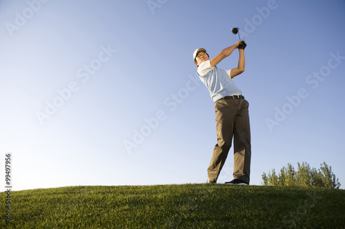 Golfer teeing off on the course