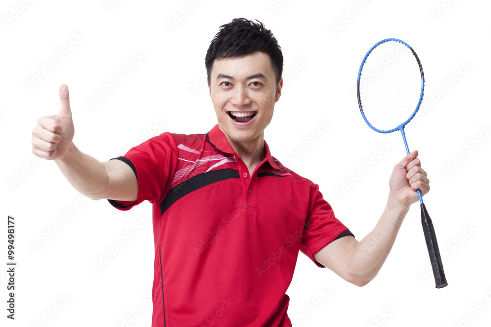 Male badminton player cheering with thumbs up Male badminton player cheering with thumbs up