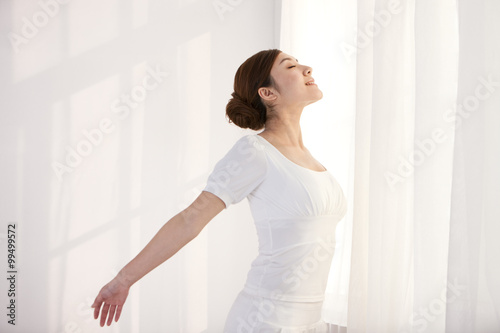 Free Download Young woman stretching with her eyes closed - GFXLoad