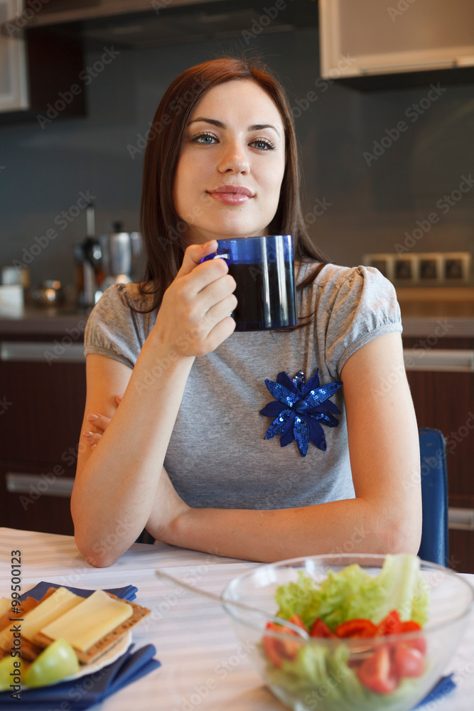 Young woman drinks her morning tea Young woman drinks her morning tea