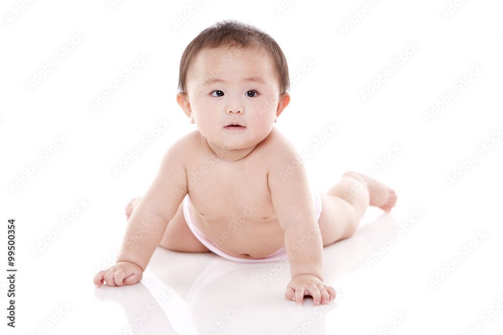 Studio shot of cute baby lying on floor Studio shot of cute baby lying on floor