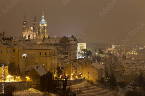 Night foggy snowy Prague City with gothic Castle, Czech republic