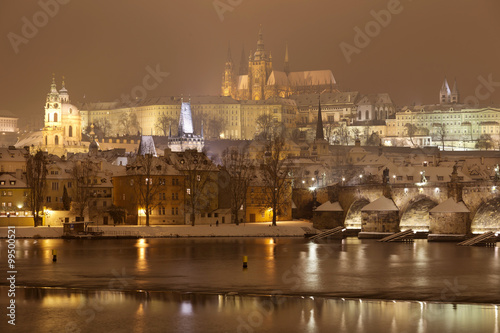 Night Prague gothic Castle and St. Nicholas' Cathedral with Charles Bridge, Czech republic