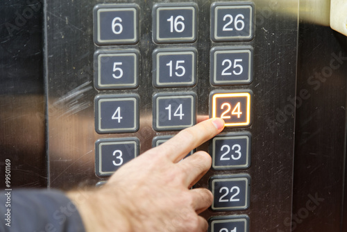 24 (twenty four) floor elevator button with light and pushing finger photo