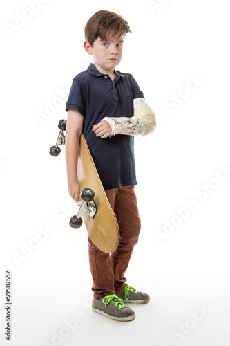 cute young boy holding a skateboard