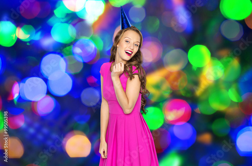 happy young woman or teen girl in party cap