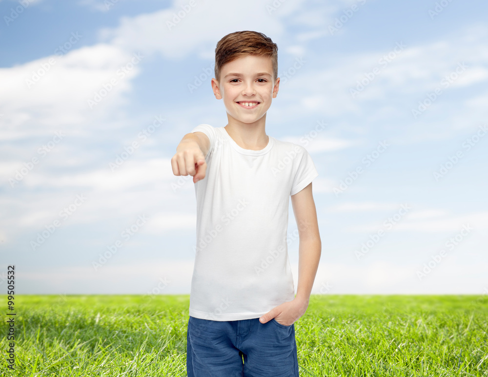 happy boy in white t-shirt pointing finger to you