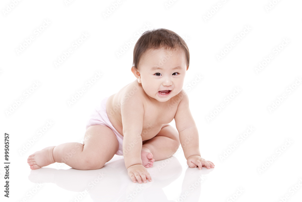 Studio shot of cute baby sitting on floor Studio shot of cute baby sitting on floor