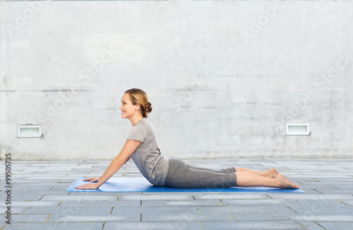 woman making yoga in dog pose on mat