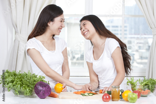 Best female friends preparing salad together