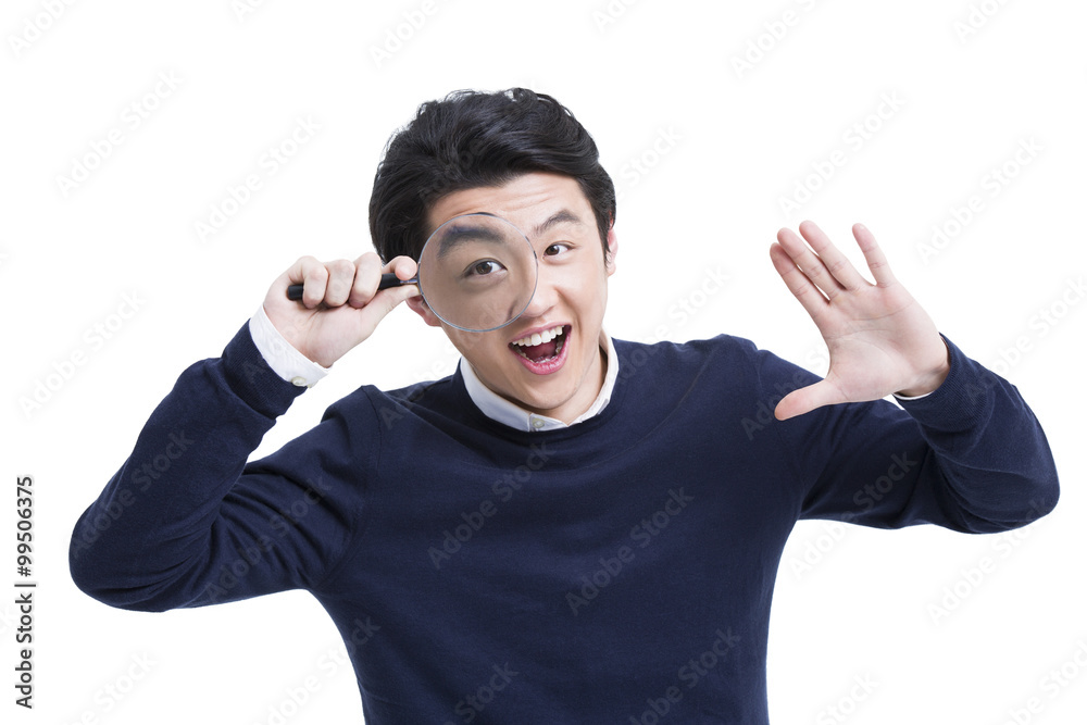 Fototapeta premium Young man with magnifying glass