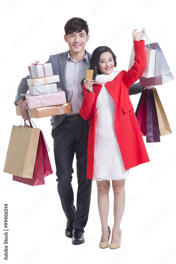 Happy young couple going shopping with gold card Happy young couple going shopping with gold card