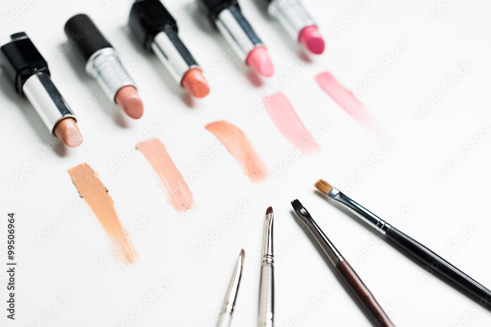 close up of lipsticks range with makeup brushes close up of lipsticks range with makeup brushes