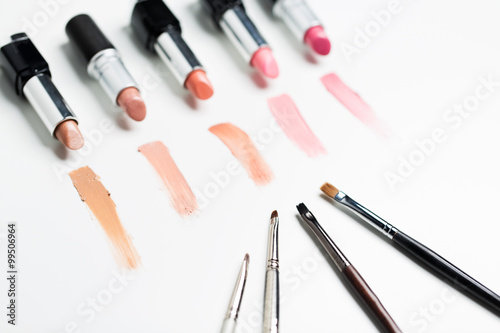 close up of lipsticks range with makeup brushes