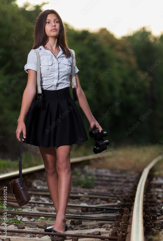 Young woman walking on railway line at sunset Young woman walking on railway line at sunset