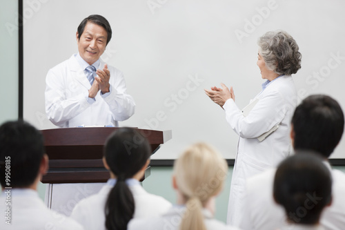 Medical workers clapping in a meeting