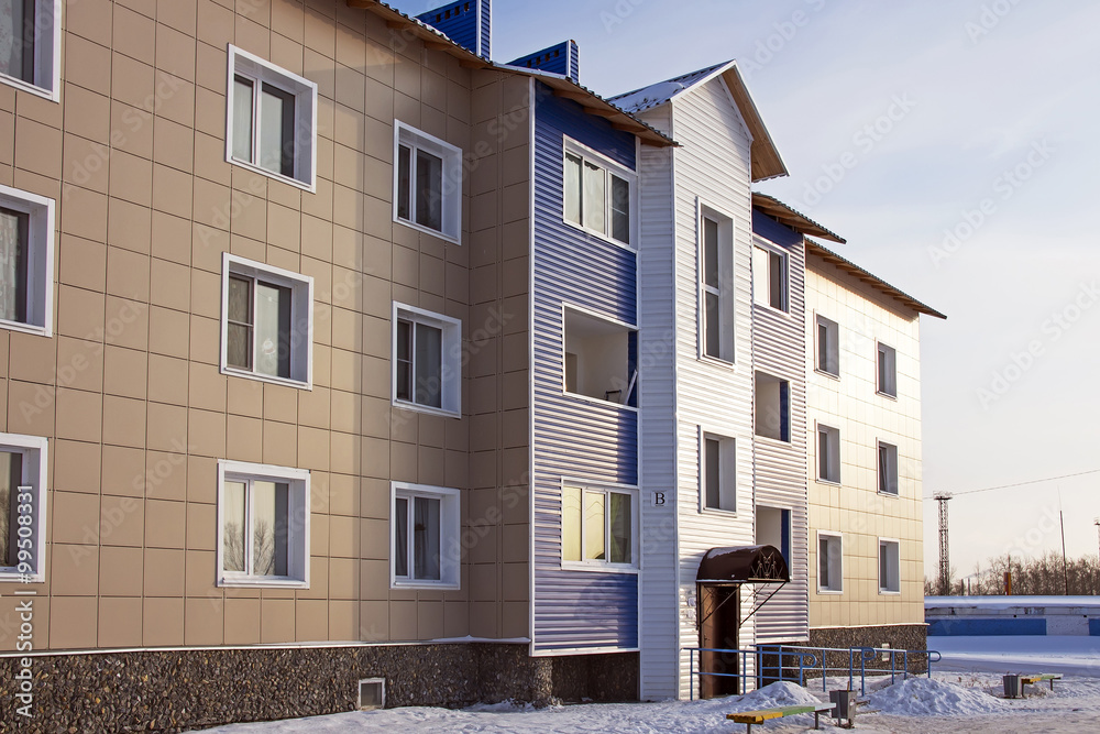Obraz premium Modern three-storey brick house in a new area of the city