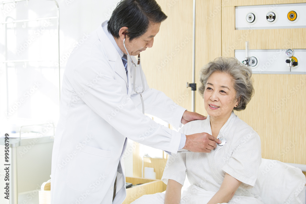 Doctor using stethoscope on patient in hospital Doctor using stethoscope on patient in hospital
