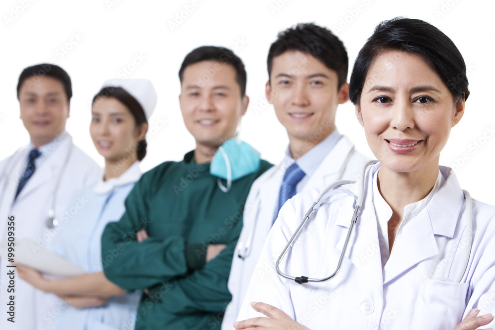 Portrait of happy female doctor with medical team in background Portrait of happy female doctor with medical team in background