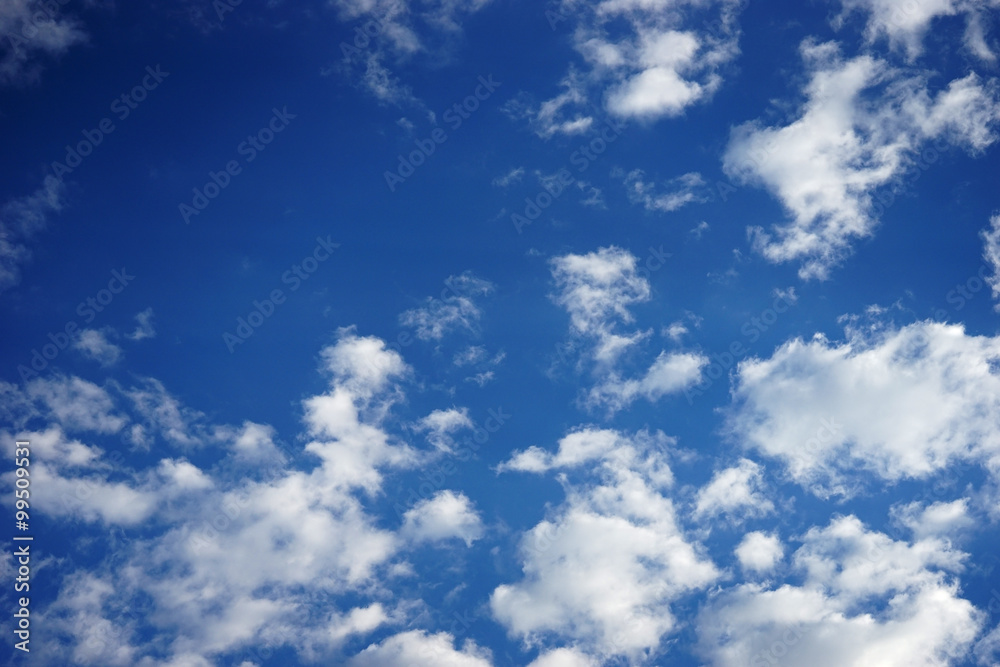 Naklejka premium white fluffy clouds in the blue sky