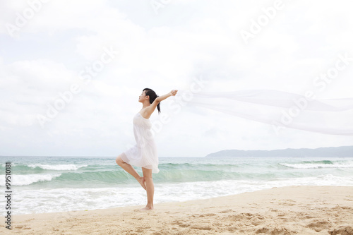A woman dancing at the beach